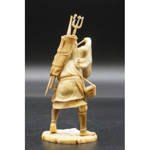 1296 - A Japanese carved ivory okimono, Meiji, depicting a crab fisherman, signed, 16.5cm high, (s.d.).... 