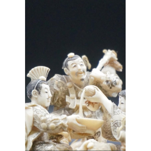 1297 - An impressive and intricate Japanese carved ivory okimono figure group, Meiji, depicting eight figur... 