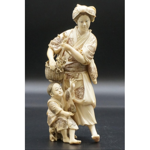 1301 - A large Japanese carved ivory okimono figure group, Meiji, depicting a mother and child with a baske... 