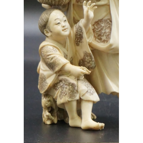 1301 - A large Japanese carved ivory okimono figure group, Meiji, depicting a mother and child with a baske... 