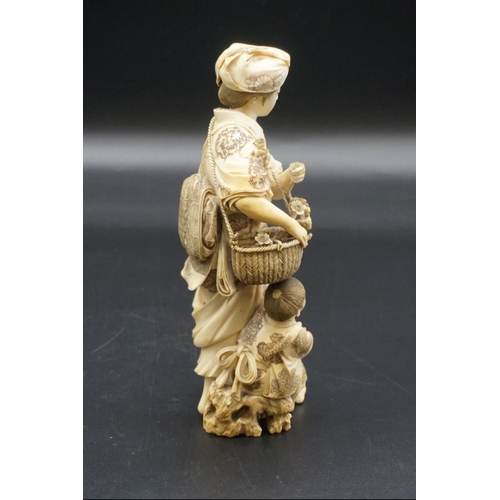 1301 - A large Japanese carved ivory okimono figure group, Meiji, depicting a mother and child with a baske... 