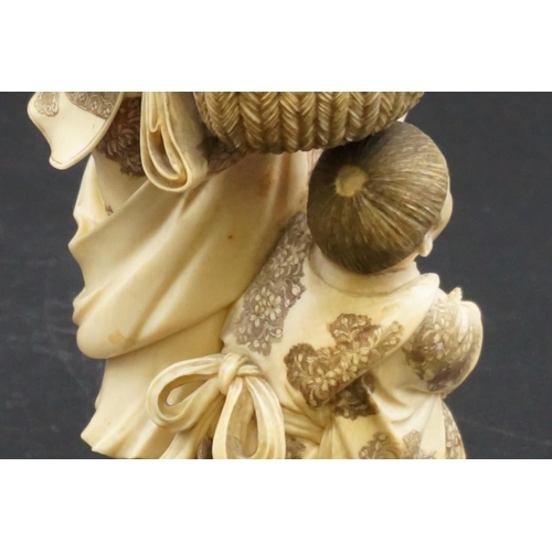 1301 - A large Japanese carved ivory okimono figure group, Meiji, depicting a mother and child with a baske... 