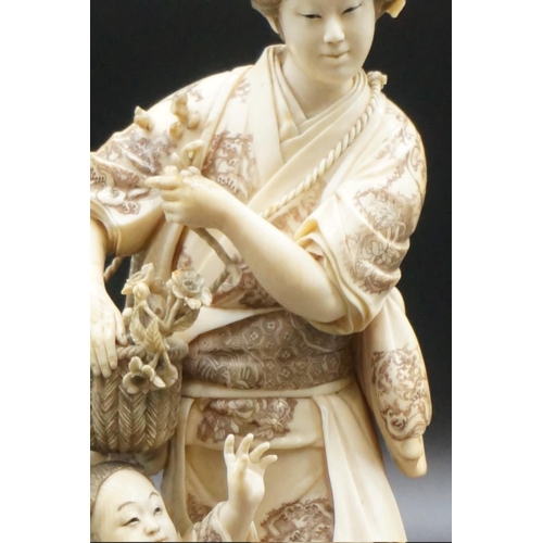 1301 - A large Japanese carved ivory okimono figure group, Meiji, depicting a mother and child with a baske... 