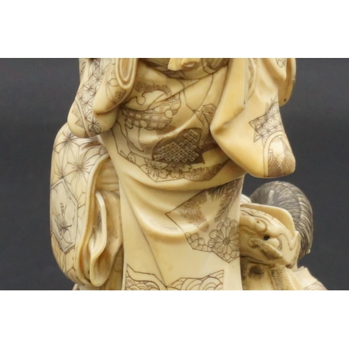 1302 - A good and large Japanese carved ivory okimono figure group, Meiji, depicting a mother and two child... 