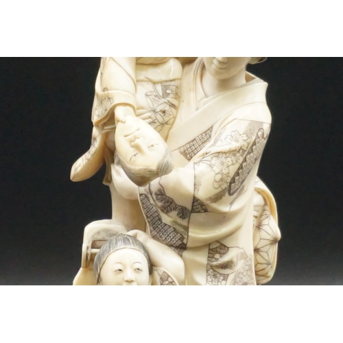 1302 - A good and large Japanese carved ivory okimono figure group, Meiji, depicting a mother and two child... 