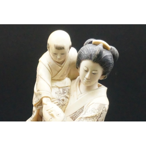 1302 - A good and large Japanese carved ivory okimono figure group, Meiji, depicting a mother and two child... 