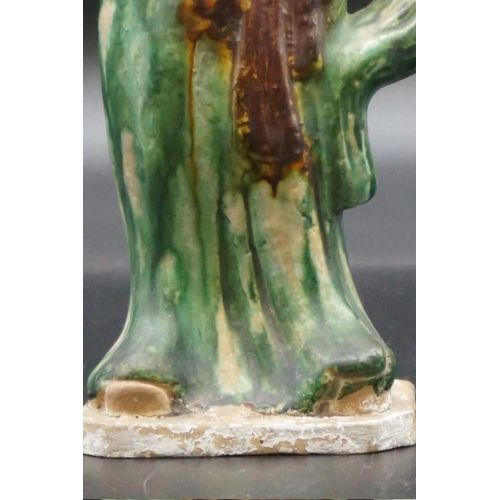 1306 - A Chinese sancai glazed pottery figure of a lady, possibly Tang, 24.5cm high. ... 