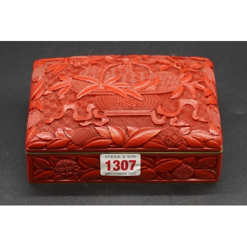 1307 - A Chinese cinnabar lacquer casket, late Qing, finely carved with a basket of fruit to the hinged cov... 