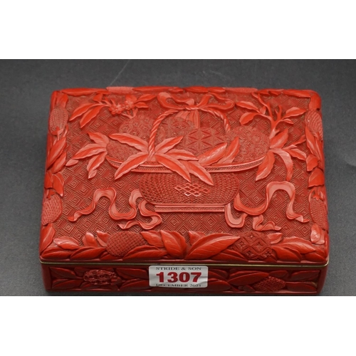 1307 - A Chinese cinnabar lacquer casket, late Qing, finely carved with a basket of fruit to the hinged cov... 