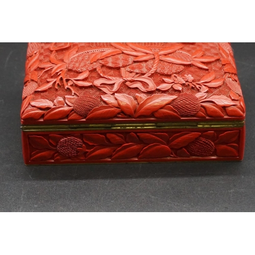 1307 - A Chinese cinnabar lacquer casket, late Qing, finely carved with a basket of fruit to the hinged cov... 