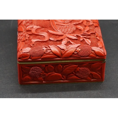 1307 - A Chinese cinnabar lacquer casket, late Qing, finely carved with a basket of fruit to the hinged cov... 