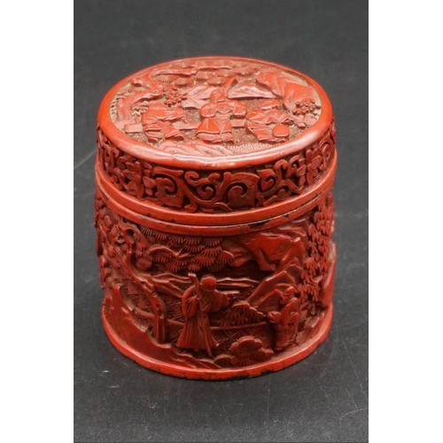 1308 - A Chinese cinnabar lacquer circular box and cover, Qing, carved with figures in a continuous landsca... 