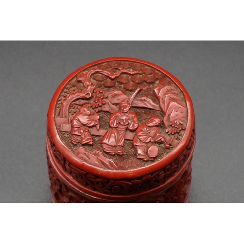 1308 - A Chinese cinnabar lacquer circular box and cover, Qing, carved with figures in a continuous landsca... 