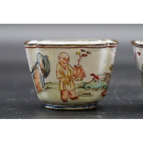 1312 - A pair of canton enamel tea bowls, Kangxi, each painted with figures in a continuous landscape, 3.3c... 