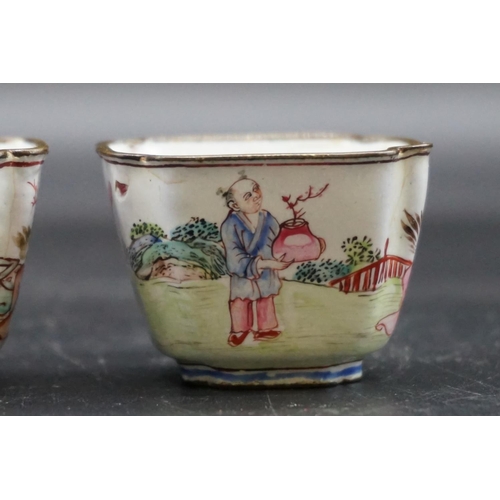 1312 - A pair of canton enamel tea bowls, Kangxi, each painted with figures in a continuous landscape, 3.3c... 