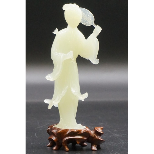 1315 - A Chinese carved celadon jade figure of Guanyin, 15cm high, on fitted wood stand, (s.d.).... 