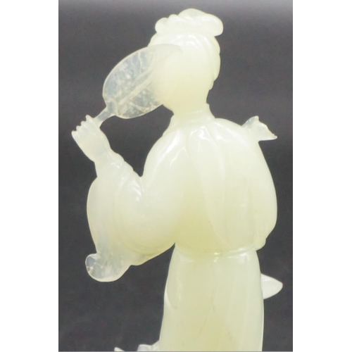 1315 - A Chinese carved celadon jade figure of Guanyin, 15cm high, on fitted wood stand, (s.d.).... 