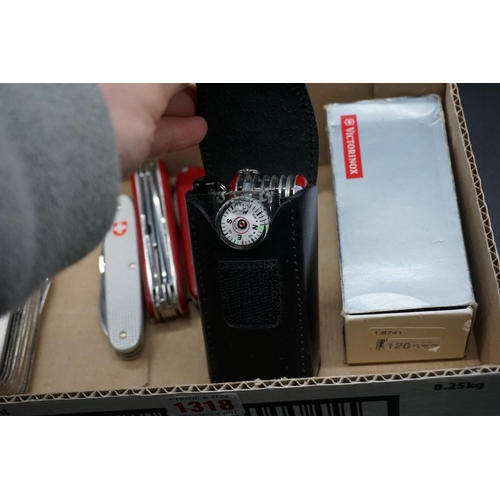 1318 - Four Victorinox Swiss Army knives, one with leather belt pouch; and another similar. ... 