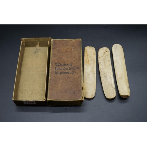 1320 - A set of three antique bone or scrimshaw items, each engraved with notches, 18cm long.... 