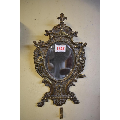 1342 - A cast brass frame mirror, 31cm high, (lacking easel). 