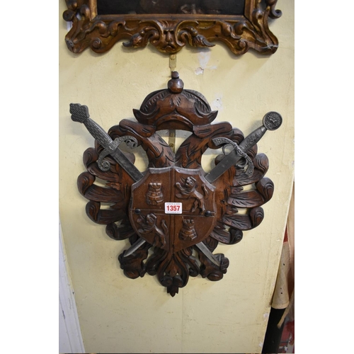 1357 - A carved walnut shield, in the manner of a coat of arms.