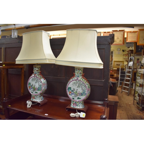 1426 - A large pair of Chinese famille rose twin handled vase form table lamps, total height including shad... 