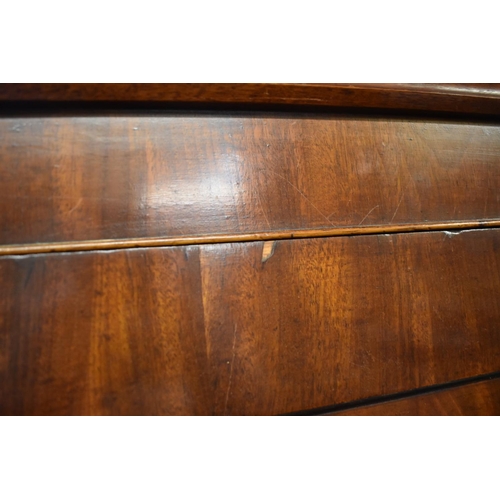 1436 - An early 19th century figured mahogany linen press, the pair of panelled doors enclosing four slidin... 