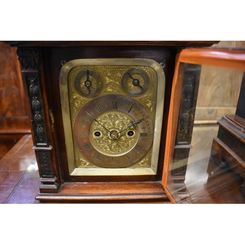 1442 - A late 19th century carved walnut twin fusee mantel clock, 34cm high, with pendulum. ... 