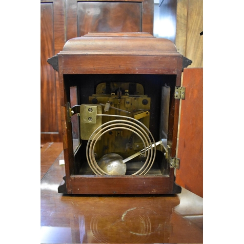 1442 - A late 19th century carved walnut twin fusee mantel clock, 34cm high, with pendulum. ... 