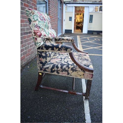 1452 - An early George III mahogany Gainsborough chair, with open arms above blind fret legs and shaped str... 