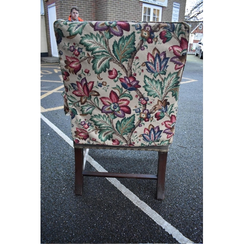 1452 - An early George III mahogany Gainsborough chair, with open arms above blind fret legs and shaped str... 