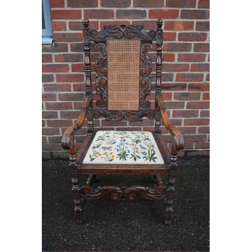 1457 - A late Victorian carved oak and cane open armchair, in the Carolean style.