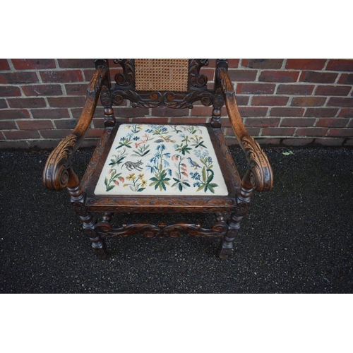 1457 - A late Victorian carved oak and cane open armchair, in the Carolean style.