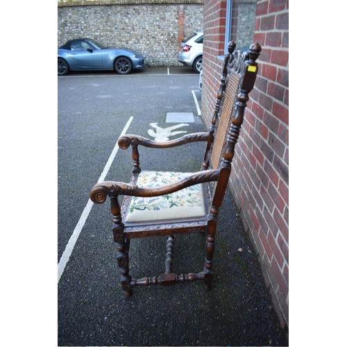 1457 - A late Victorian carved oak and cane open armchair, in the Carolean style.