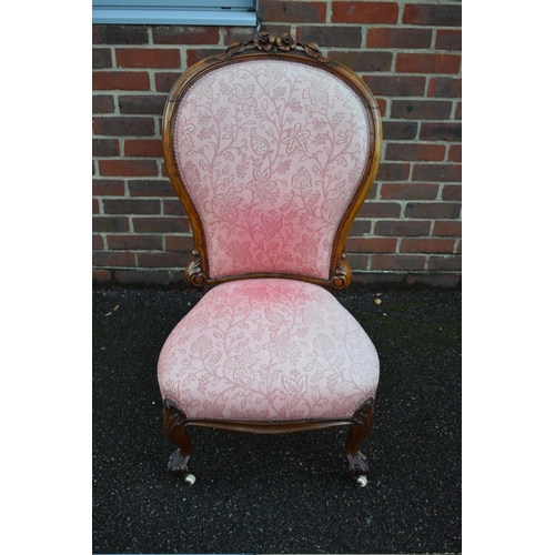 1458 - A Victorian carved walnut and pink damask nursing chair.... 