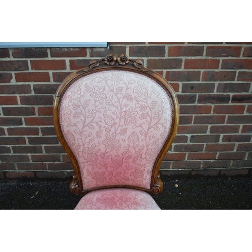 1458 - A Victorian carved walnut and pink damask nursing chair.... 