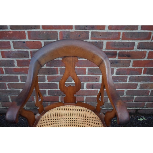 1460 - A late Victorian mahogany and cane revolving desk chair. 