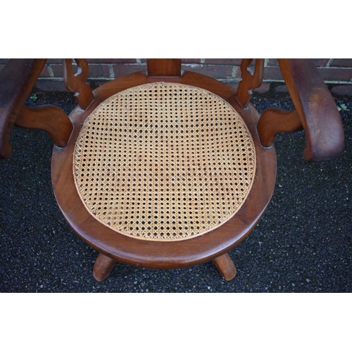 1460 - A late Victorian mahogany and cane revolving desk chair. 