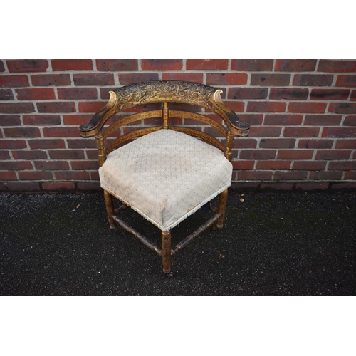 1465 - A 19th century giltwood corner chair, with heavily carved back rail.