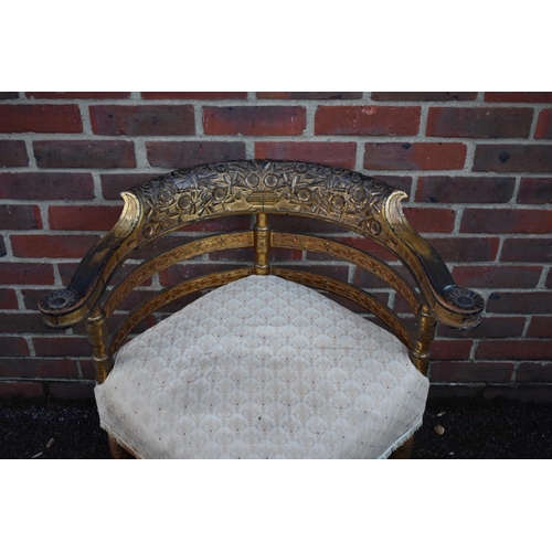 1465 - A 19th century giltwood corner chair, with heavily carved back rail.