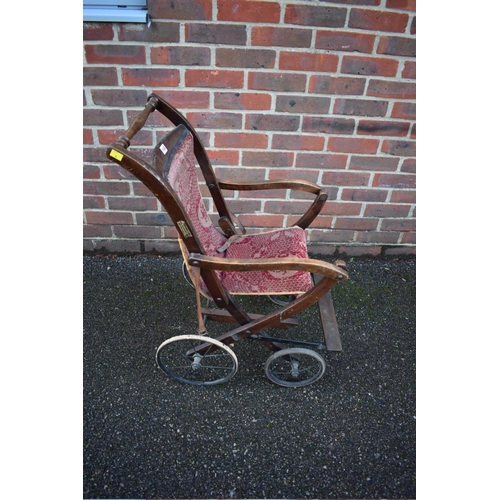 1466 - An antique child's beech wheelchair, labelled 'Vernall's'.  