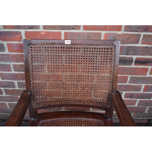 1467 - A Colonial teak and cane planter's chair.