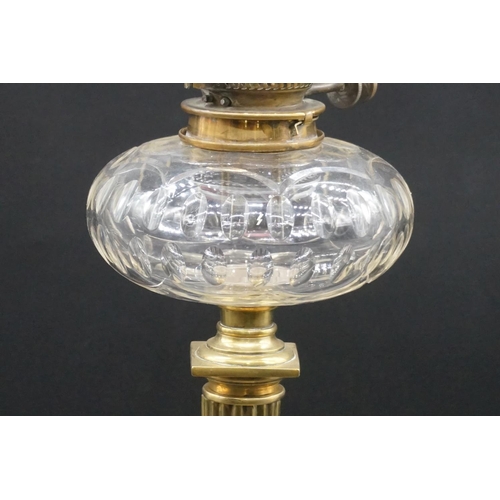 1471 - An antique brass oil lamp, with etched and cranberry stained shade, height including shade 65cm.... 