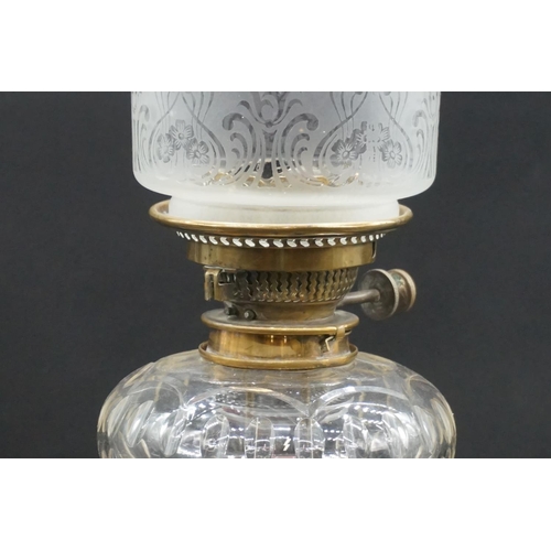 1471 - An antique brass oil lamp, with etched and cranberry stained shade, height including shade 65cm.... 