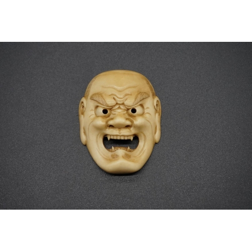 1244 - A good Japanese carved ivory Noh mask netsuke of Shikami, probably Edo, 4.2cm.