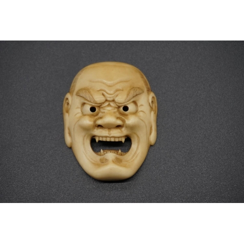 1244 - A good Japanese carved ivory Noh mask netsuke of Shikami, probably Edo, 4.2cm.