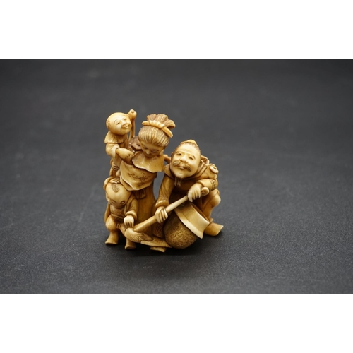 1247 - A good and large Japanese carved ivory netsuke figure group, 19th century, depicting a man, woman an... 