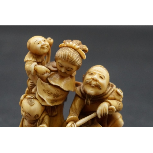 1247 - A good and large Japanese carved ivory netsuke figure group, 19th century, depicting a man, woman an... 