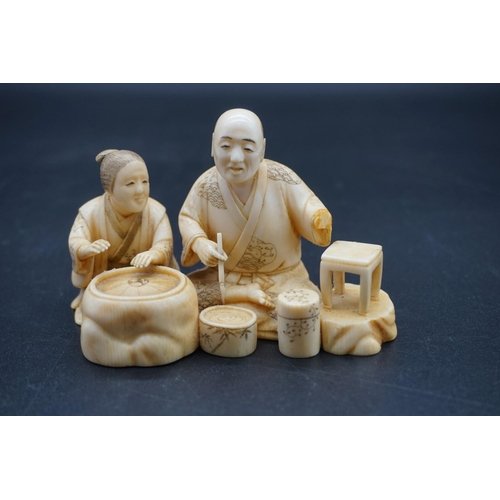 1248 - A Japanese carved ivory okimono, Meiji, depicting two seated figures, one holding a brush, signed, s... 