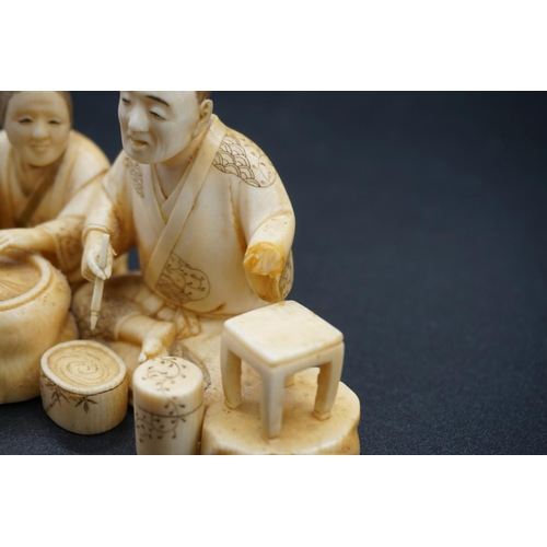 1248 - A Japanese carved ivory okimono, Meiji, depicting two seated figures, one holding a brush, signed, s... 